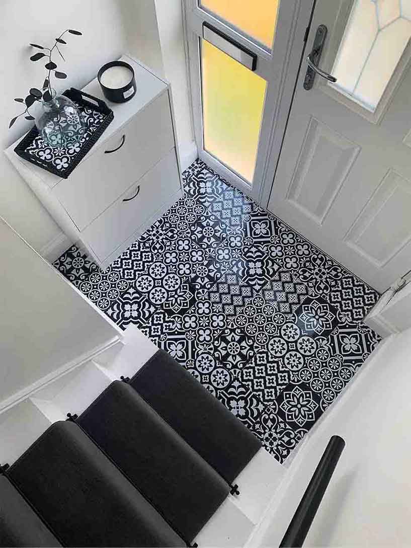 White entrance and hallway with patterned tiles