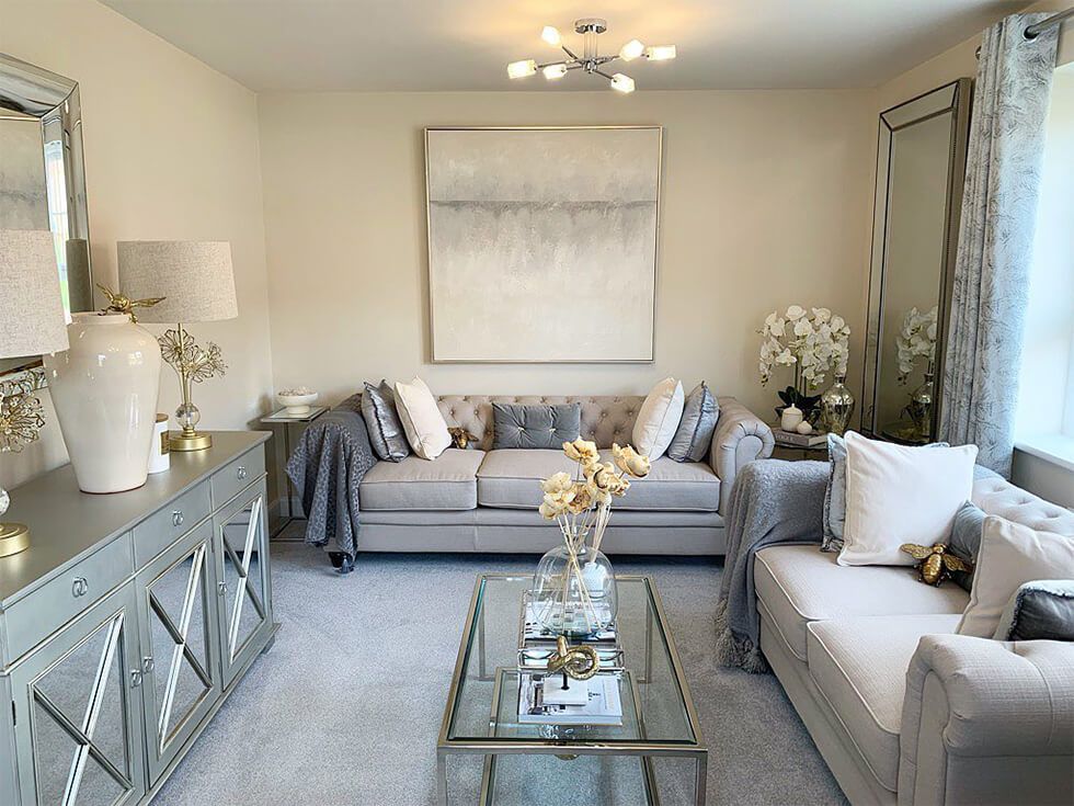 The Hampton oatmeal sofas and metallic accessories in the living room