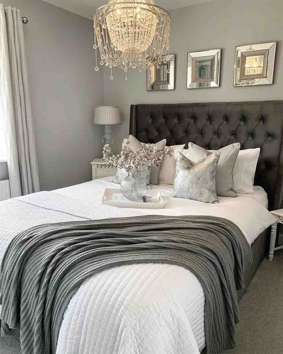 Grey and white bedroom with chandelier