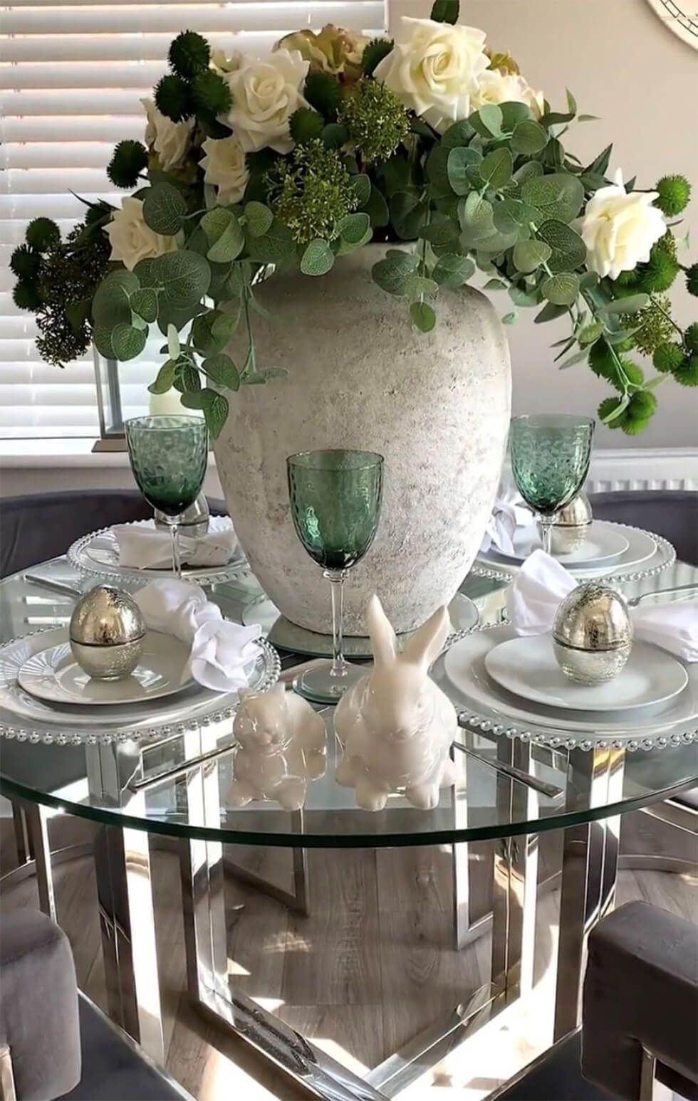  A glass and chrome dining set with a stylish tablescape