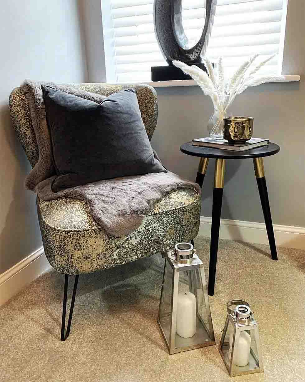 A metallic armchair and a side table 