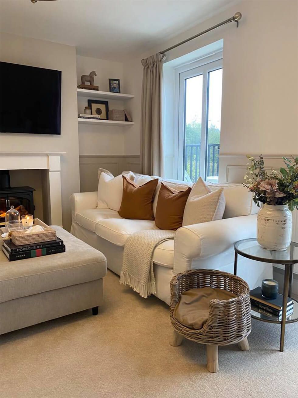 A cosy living room with a white sofa and rustic accessories