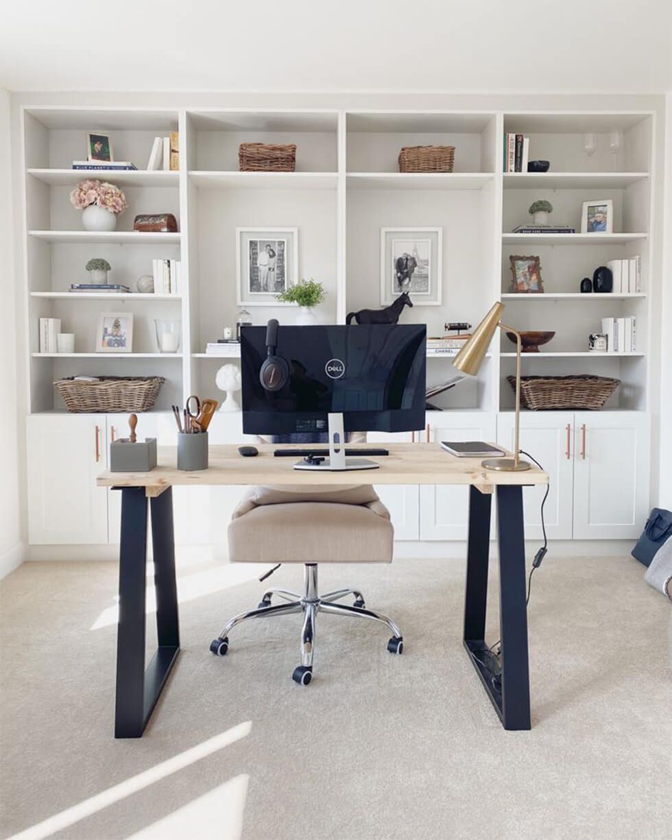A neutral home office with built-in bookshelves