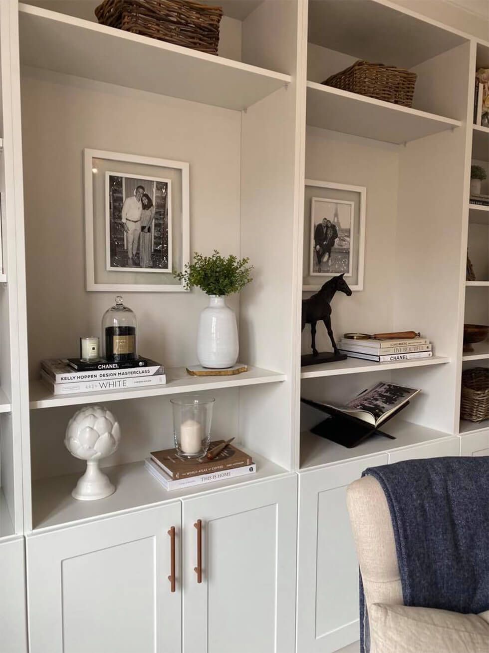 Built-in bookshelves styled with candles, books and framed photographs