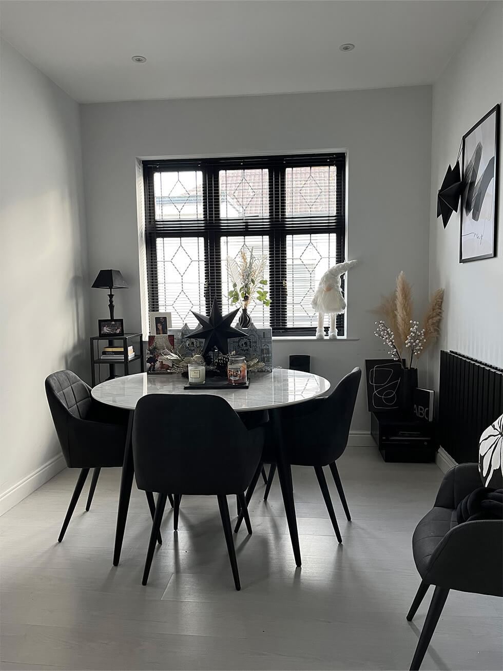 Cosy monochrome dining room with round dining set