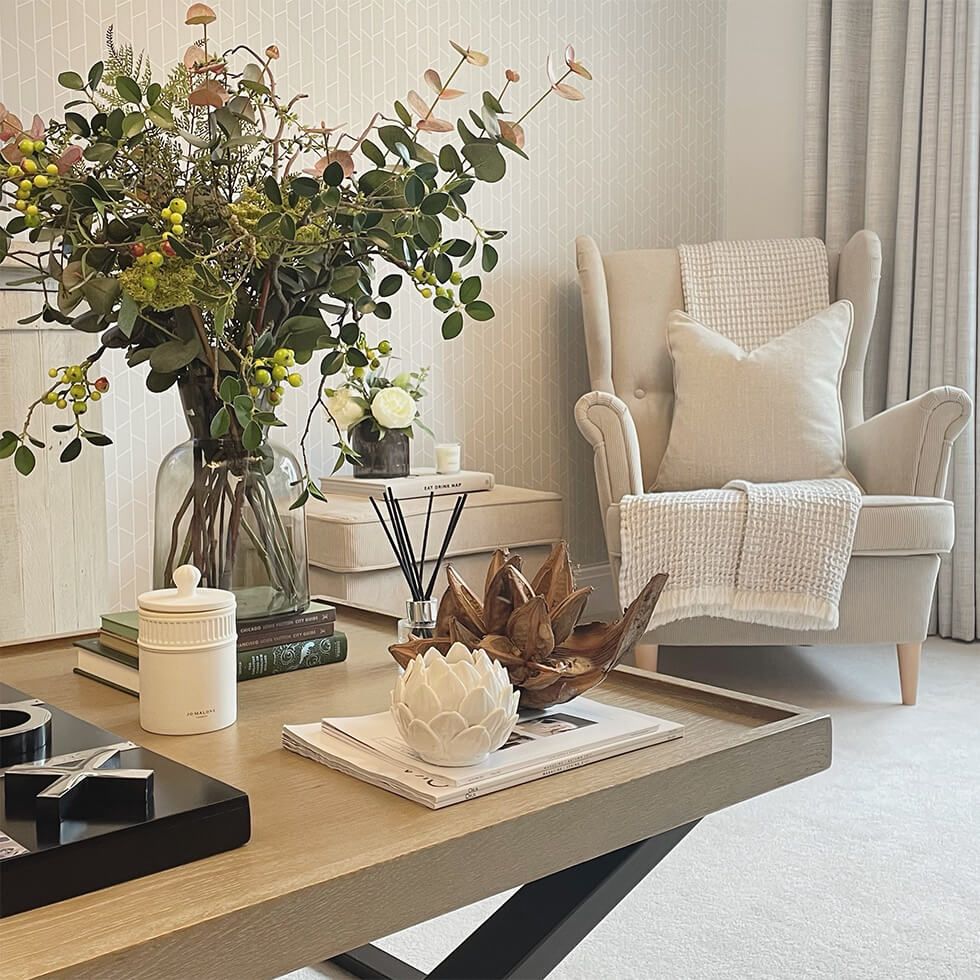 Living room with cosy fabric armchair and coffee table