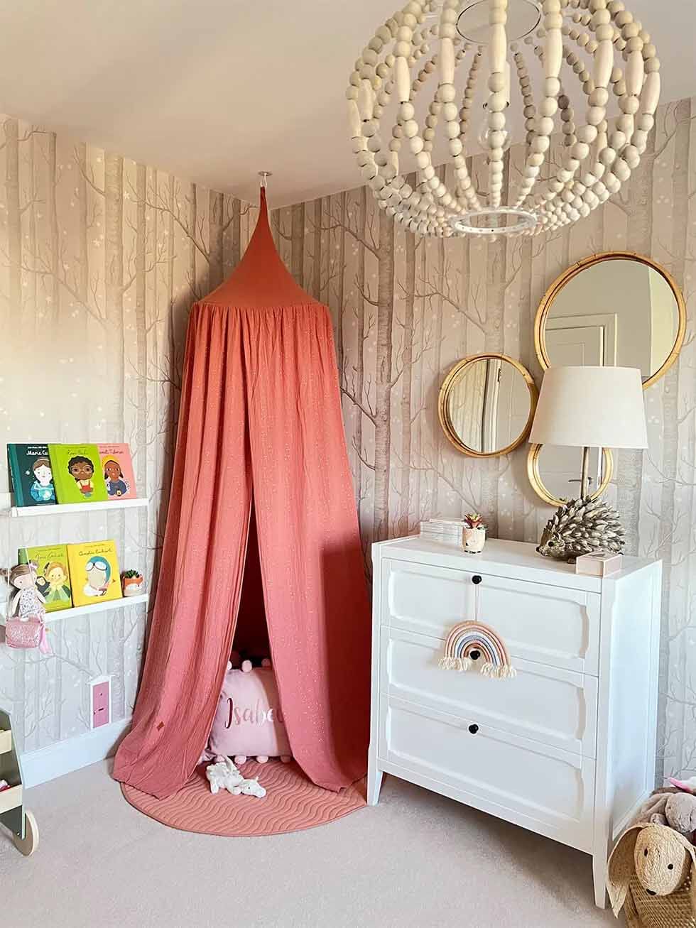Kids fairytale themed bedroom with pink canopy and wallpaper