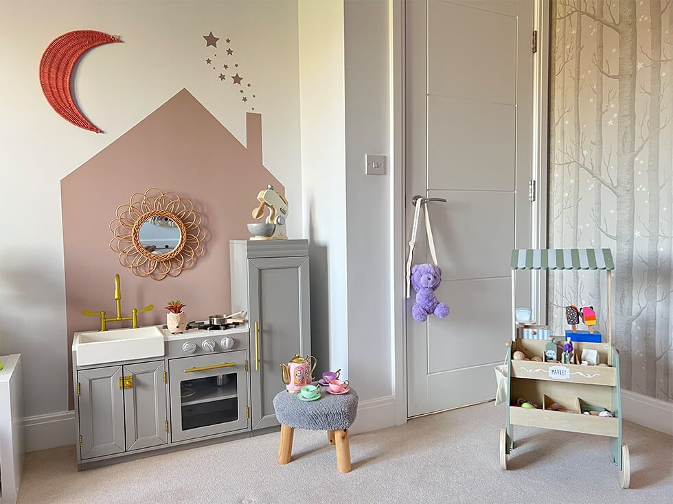 Cosy play corner with painted silhouette of a house