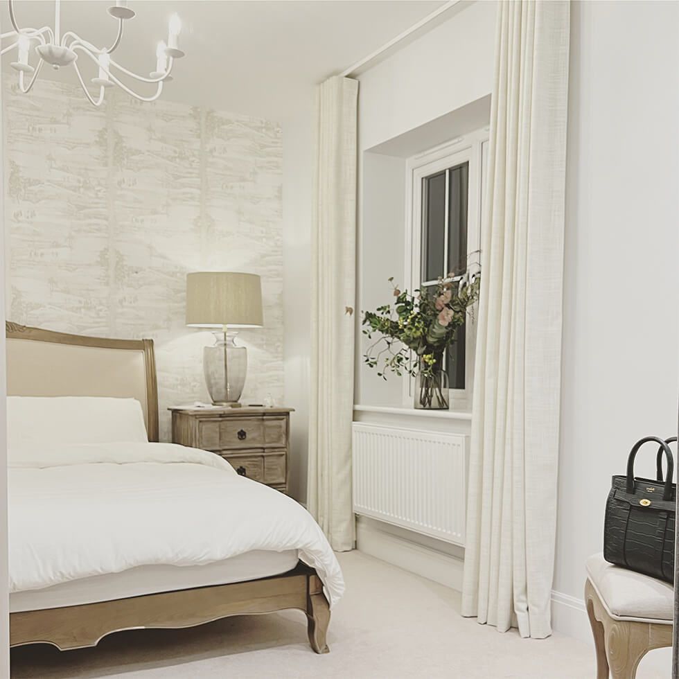 Earthy and neutral bedroom with wooden bed and wallpaper