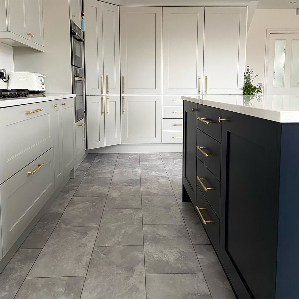 A modern two-tone kitchen with grey and navy cabinets