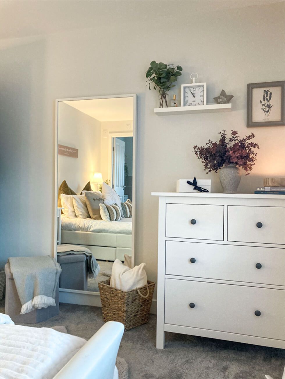 White drawers and woven baskets in a modern country bedroom