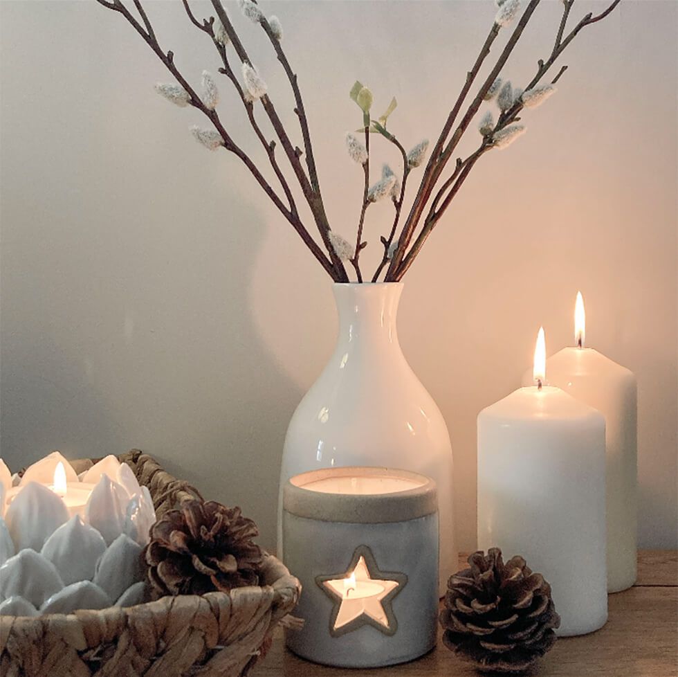  Candles and vases grouped together in a cosy nook