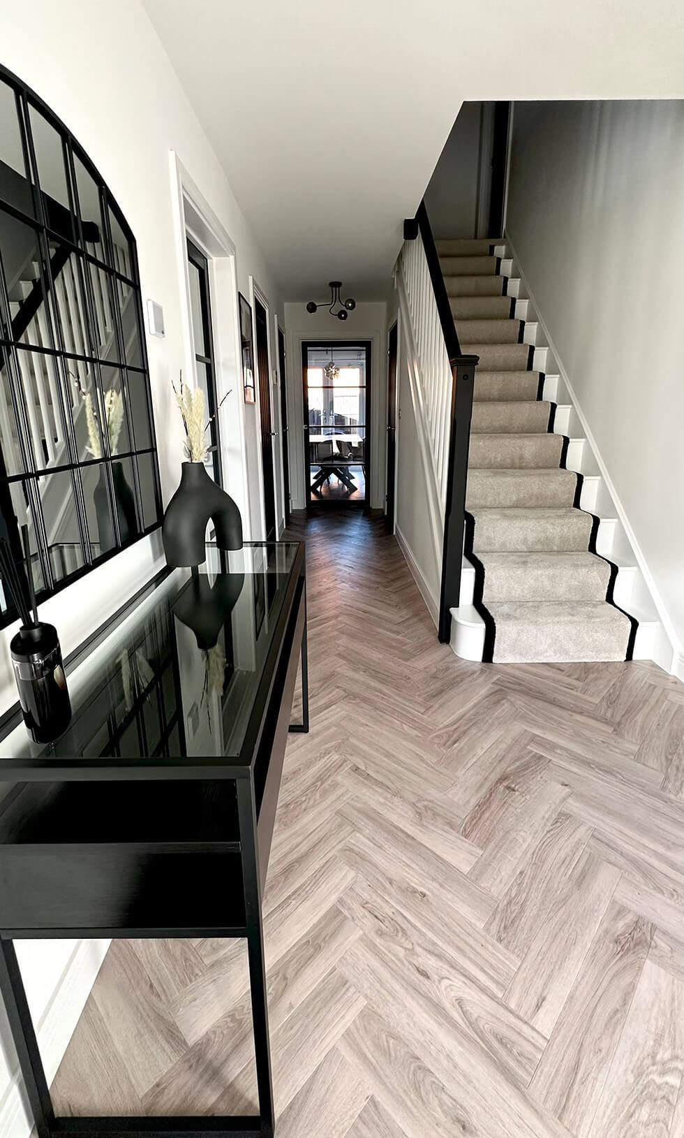 Light and airy hallway with black accessories and furniture