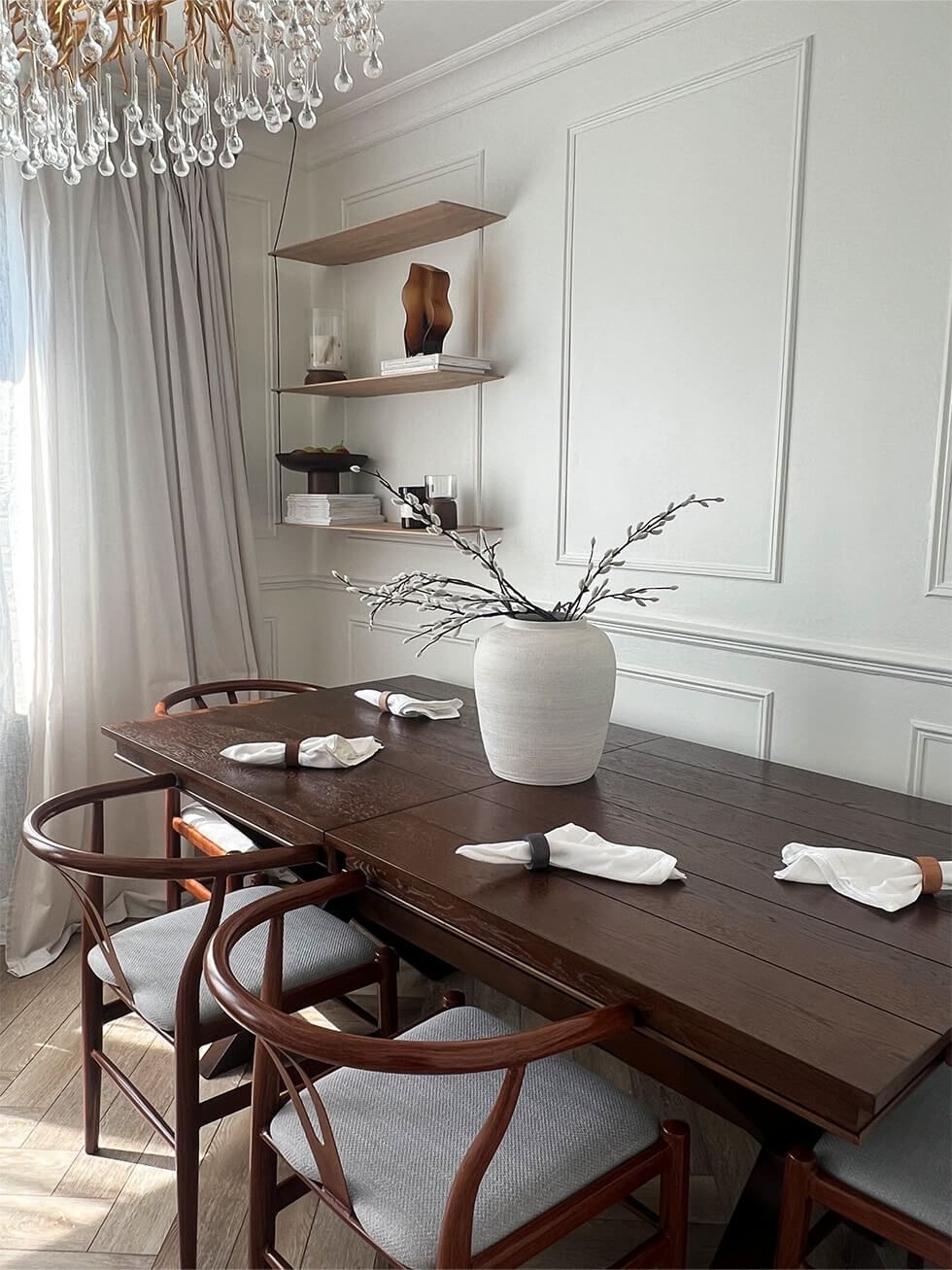 Dark wood dining table in glamorous white dining room