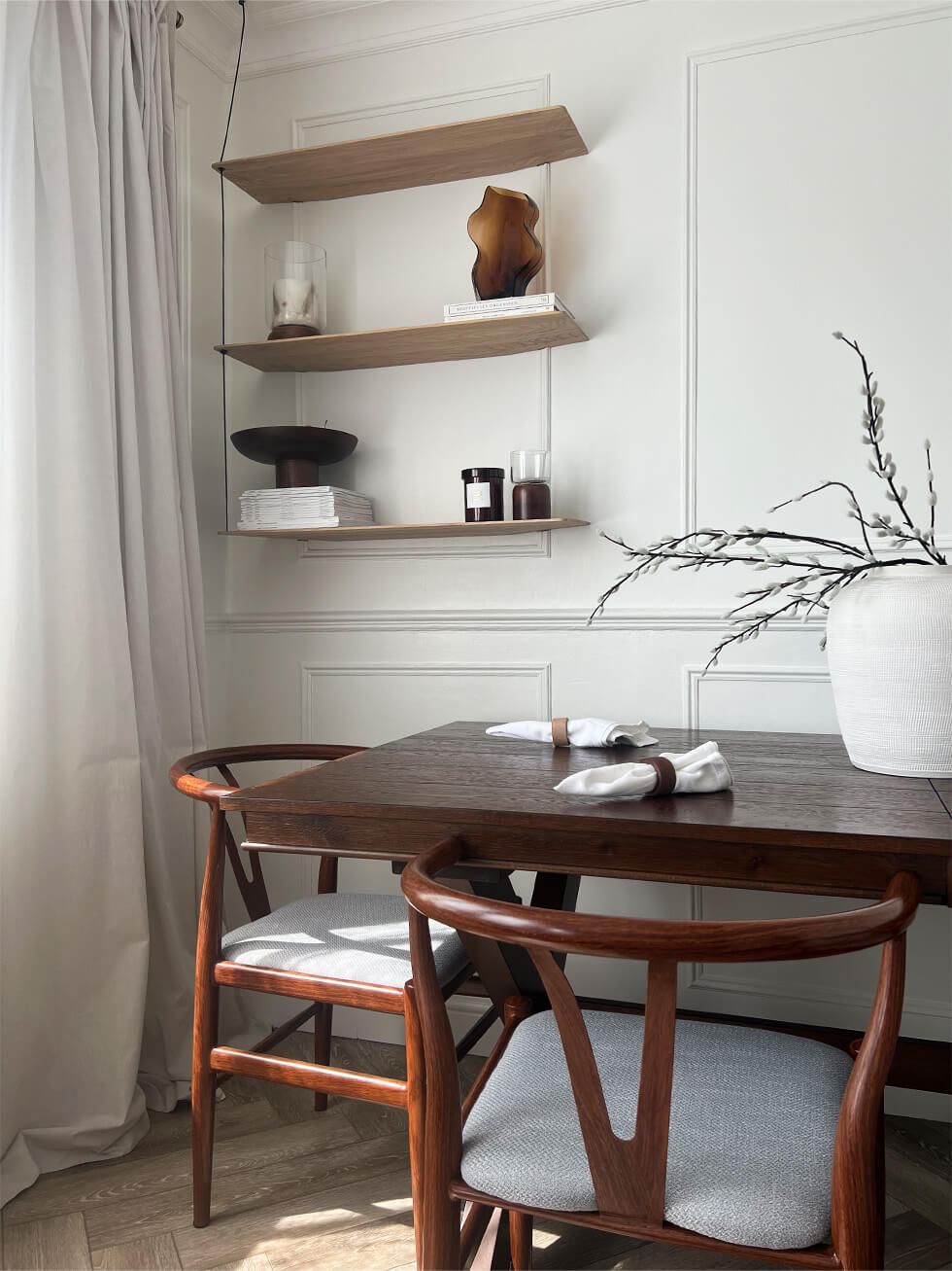 Elegant dining room with dark wood dining table and shelves