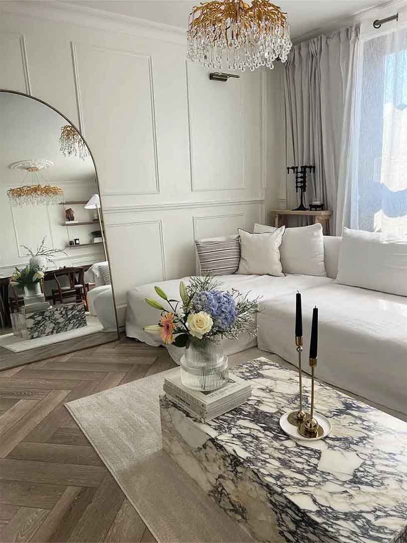 Neutral white living room with a white sofa and marble coffee table
