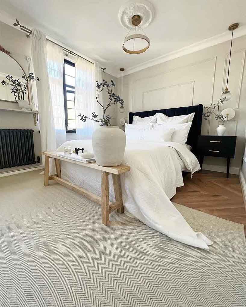 Sophisticated white bedroom with statement velvet bed