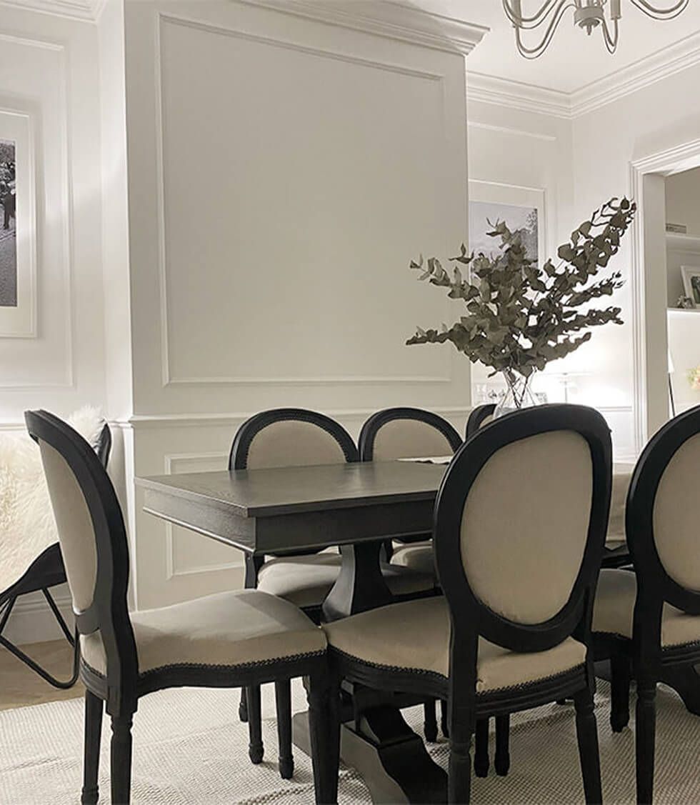 Dining room with grey wood dining table and wooden fabric chairs