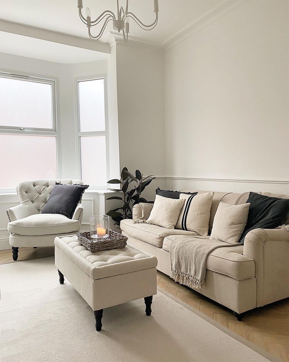 Neutral chic living room with button back details and ottoman