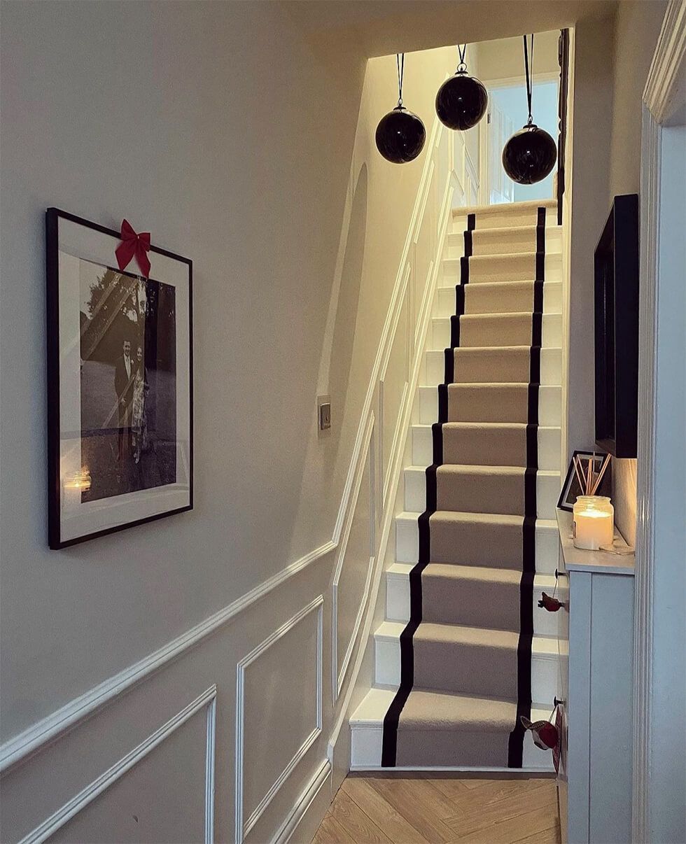 Classic entryway with carpet on staircase