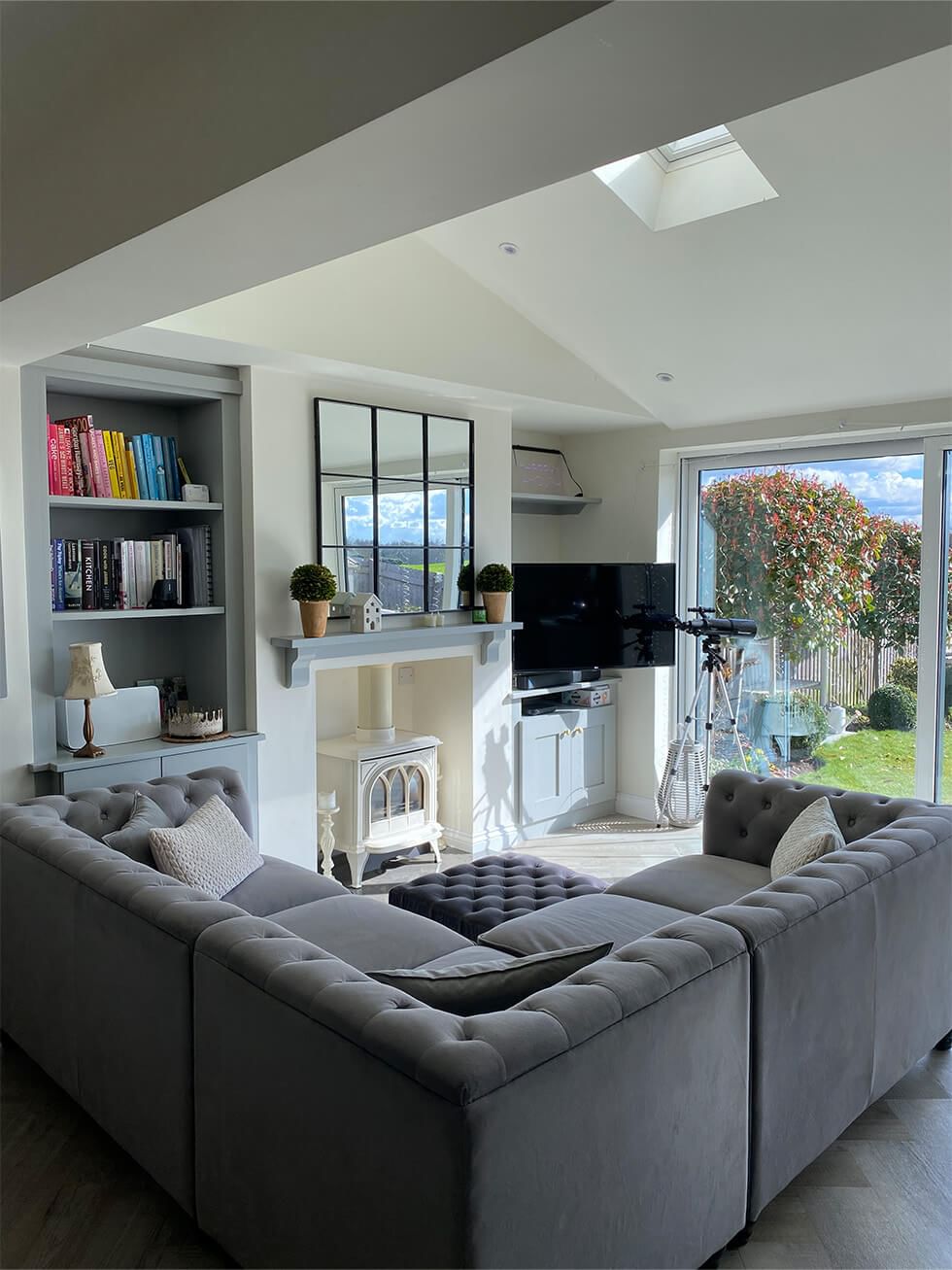 Open space living room with grey Chesterfield sofa