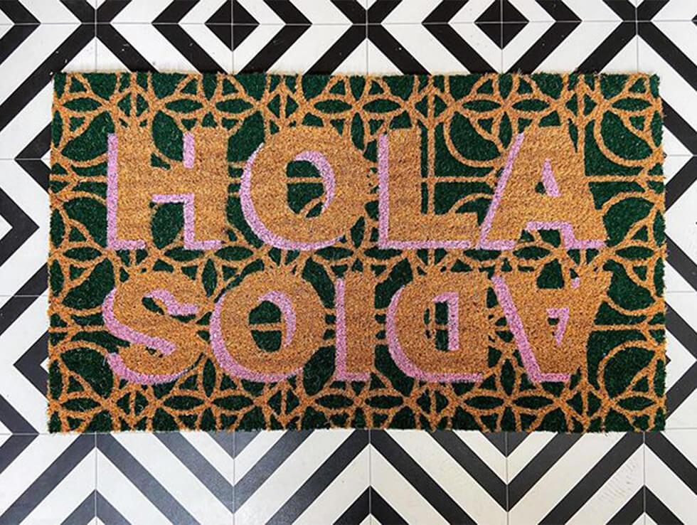 doormat that says hola and adios in a bold print