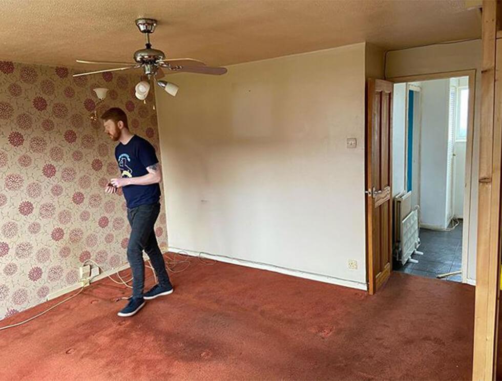 empty living room with red carpet floors and wallpaper