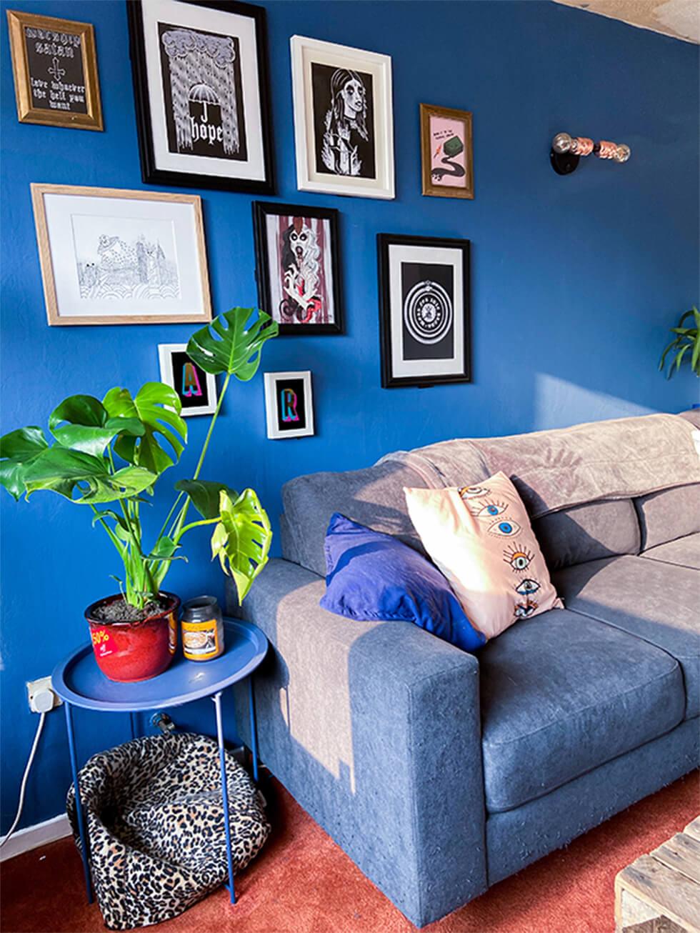 dark grey fabric corner sofa in a modern blue living room