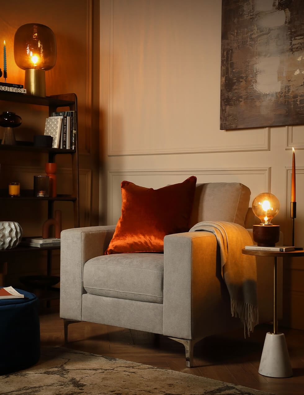 Grey armchair in a reading nook with a warm neutral palette