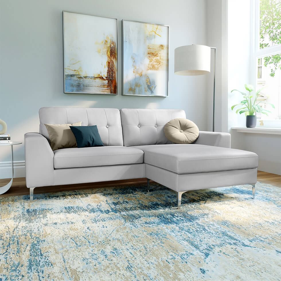 A stylish light grey L-shape corner sofa with square and round cushions