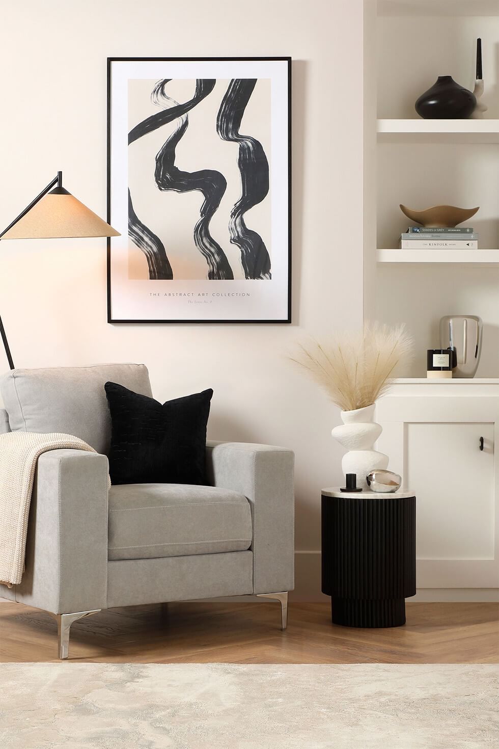 Chic monochrome reading corner with a grey armchair