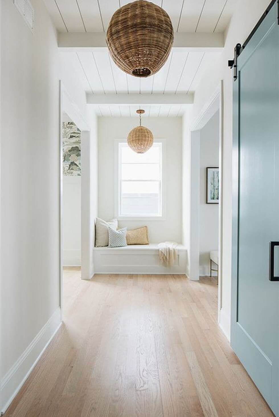 White and airy hallway with rattan lamps