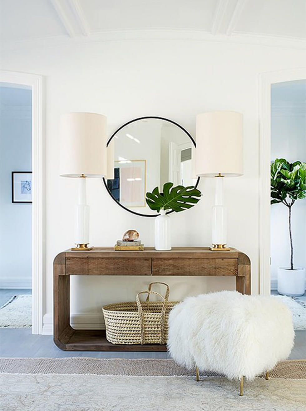 Round mirror with wooden sideboard