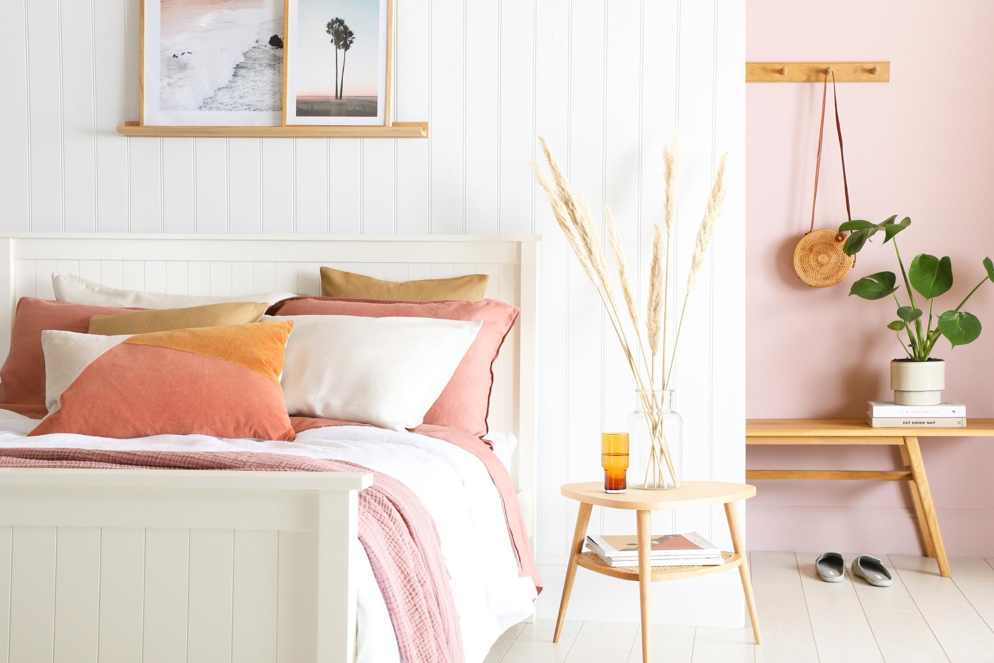 Bedroom with white wall panels and pink touches