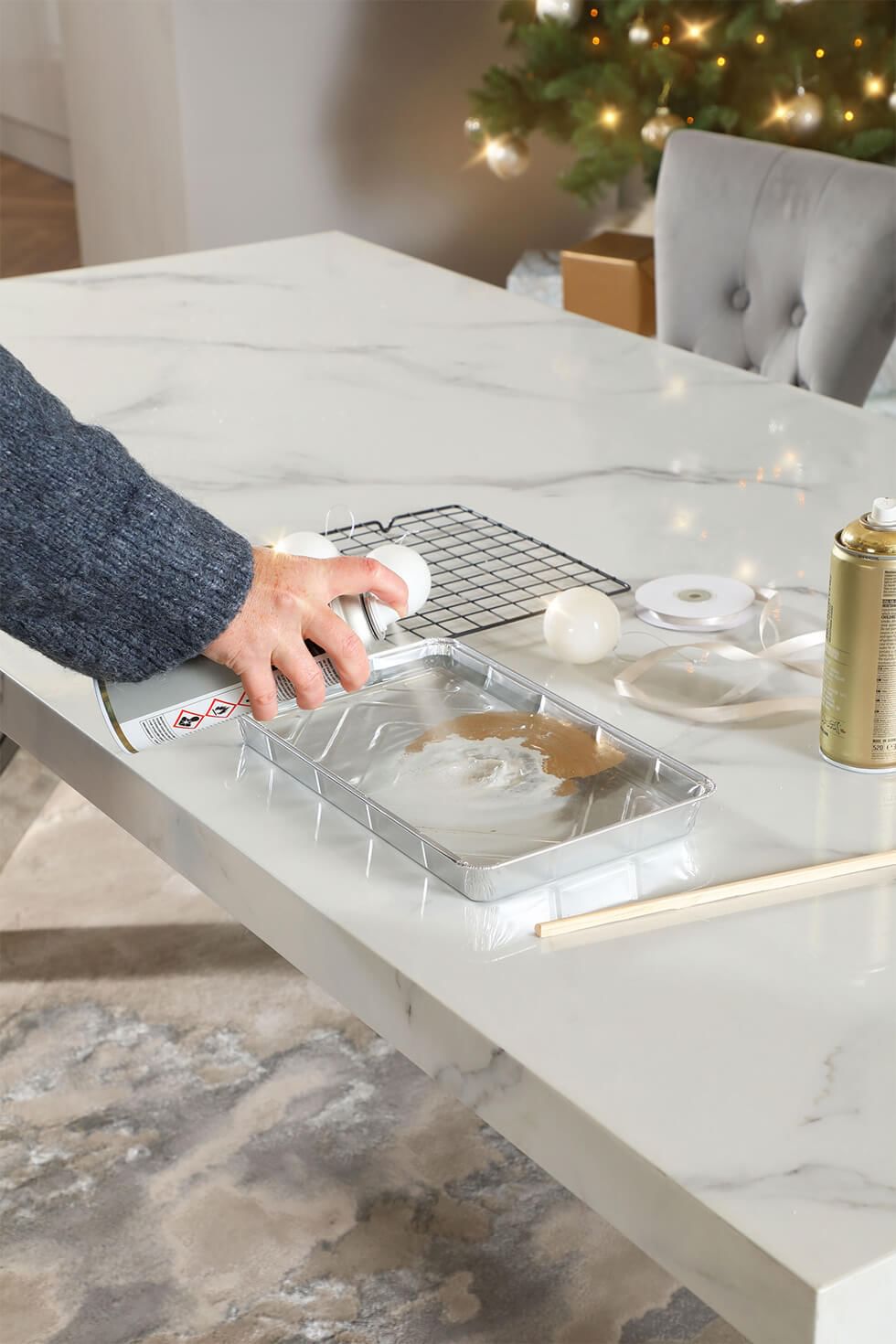 Spray the paint on the tray