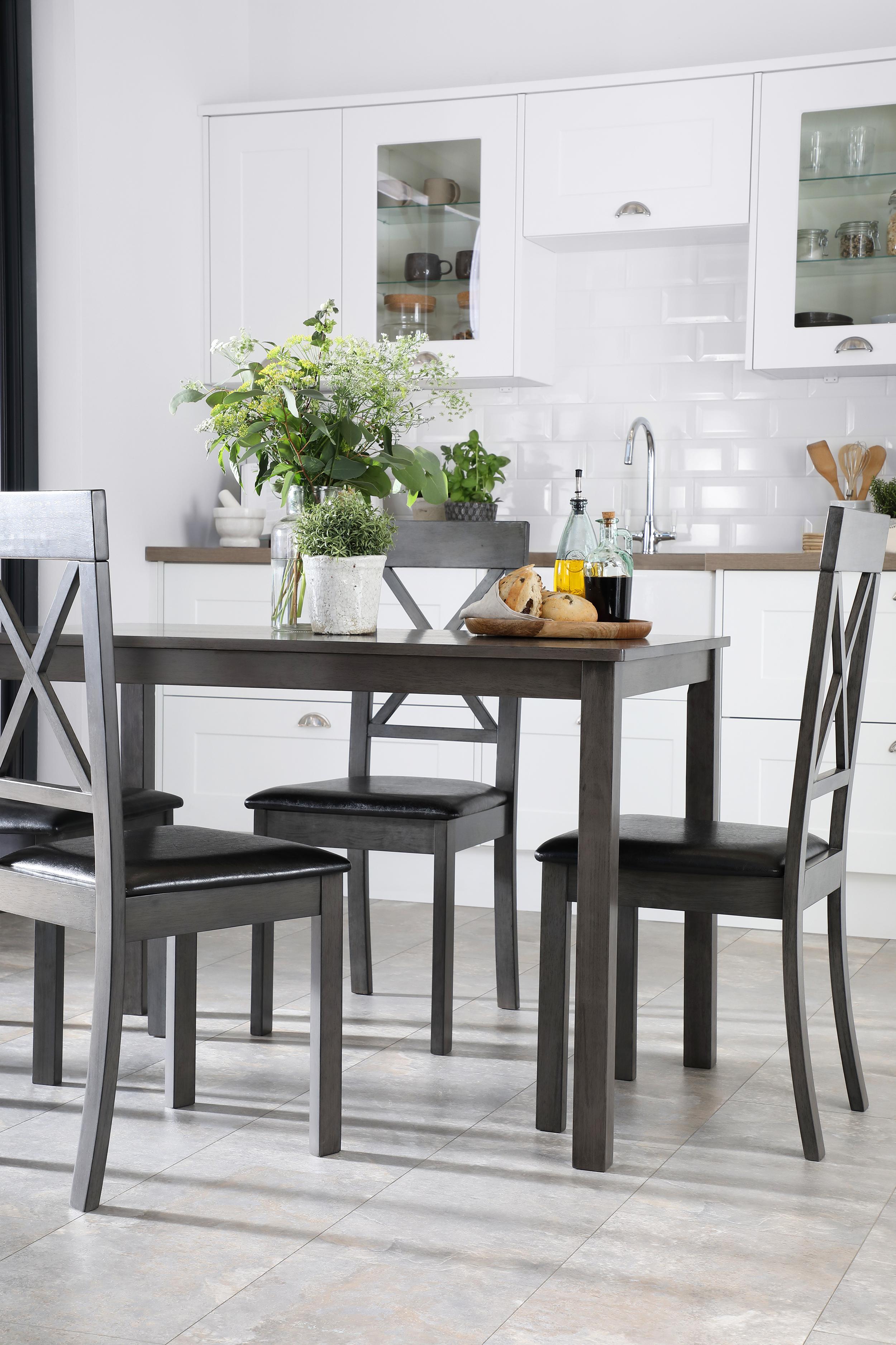 painted black wooden dining table with x back d ining chairs in a contemporary open plan space