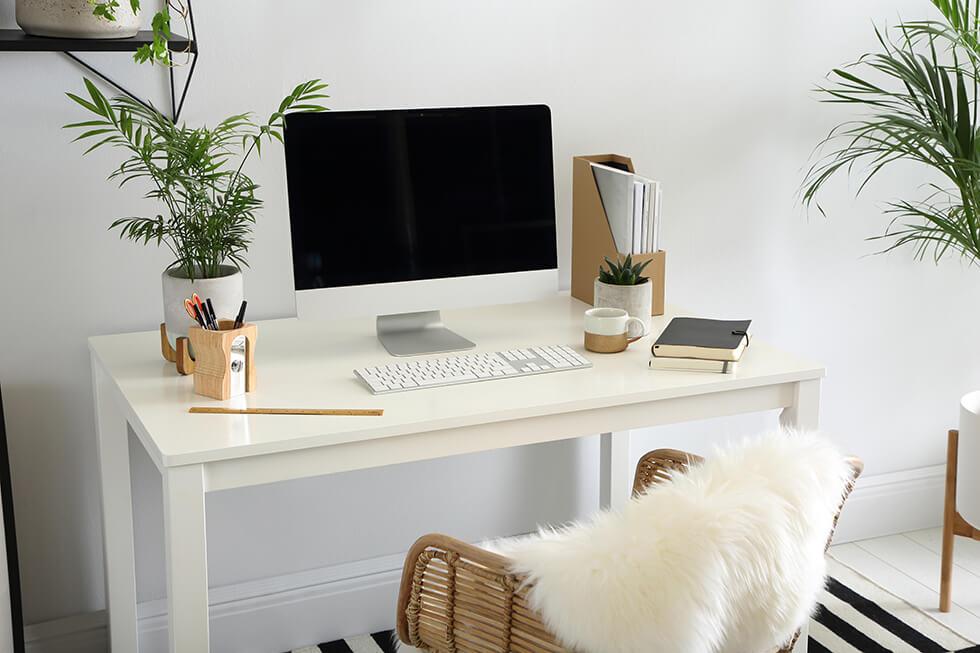 white dining table used as a work desk in a modern home office