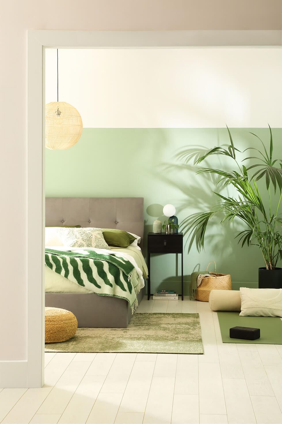 Green bedroom with grey fabric bed