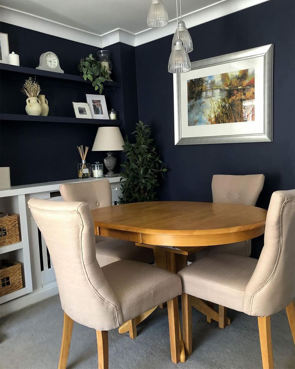 Dining room with round wooden dining table and fabric dining chairs