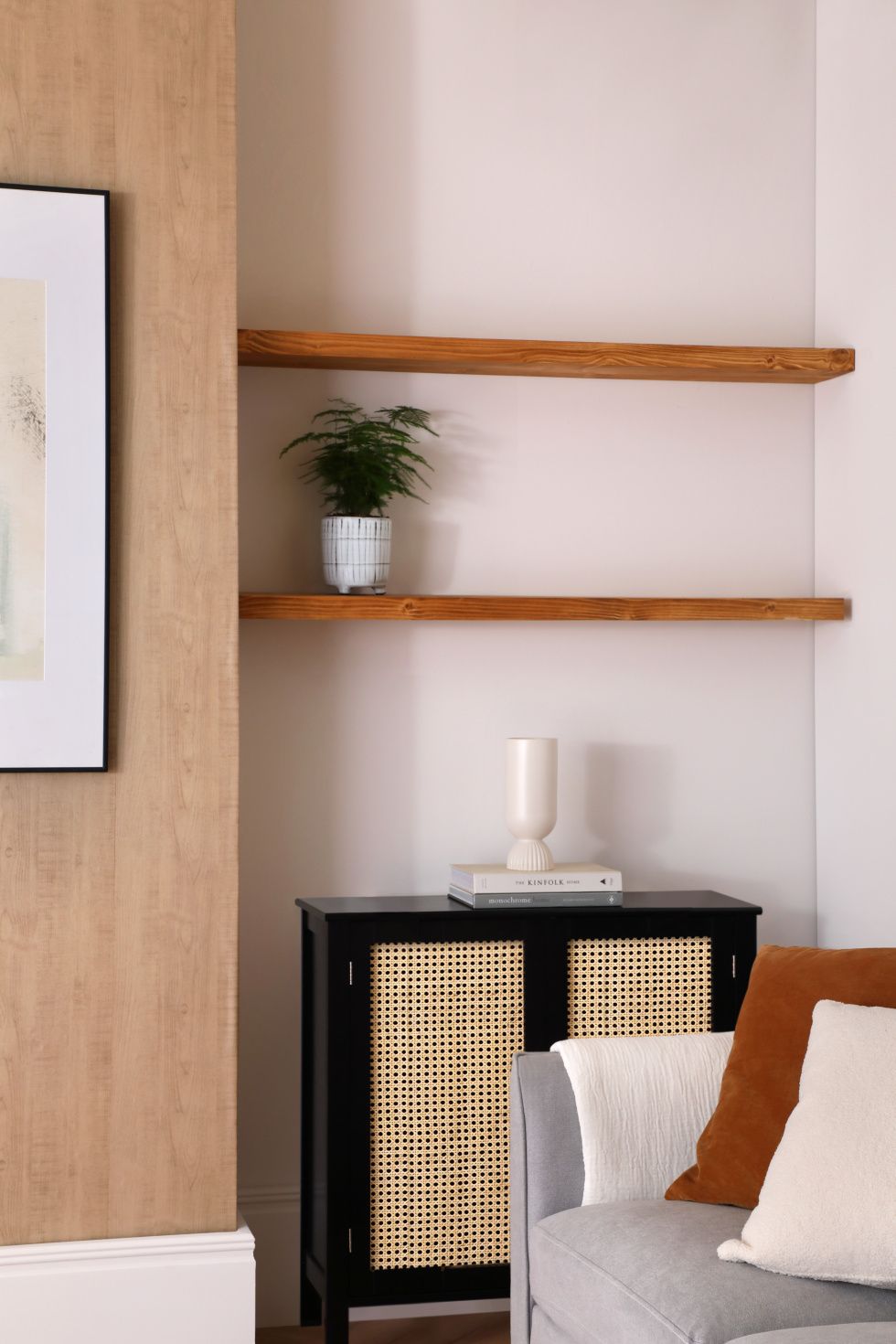 Modern living room with a potted plant on the wooden shelf