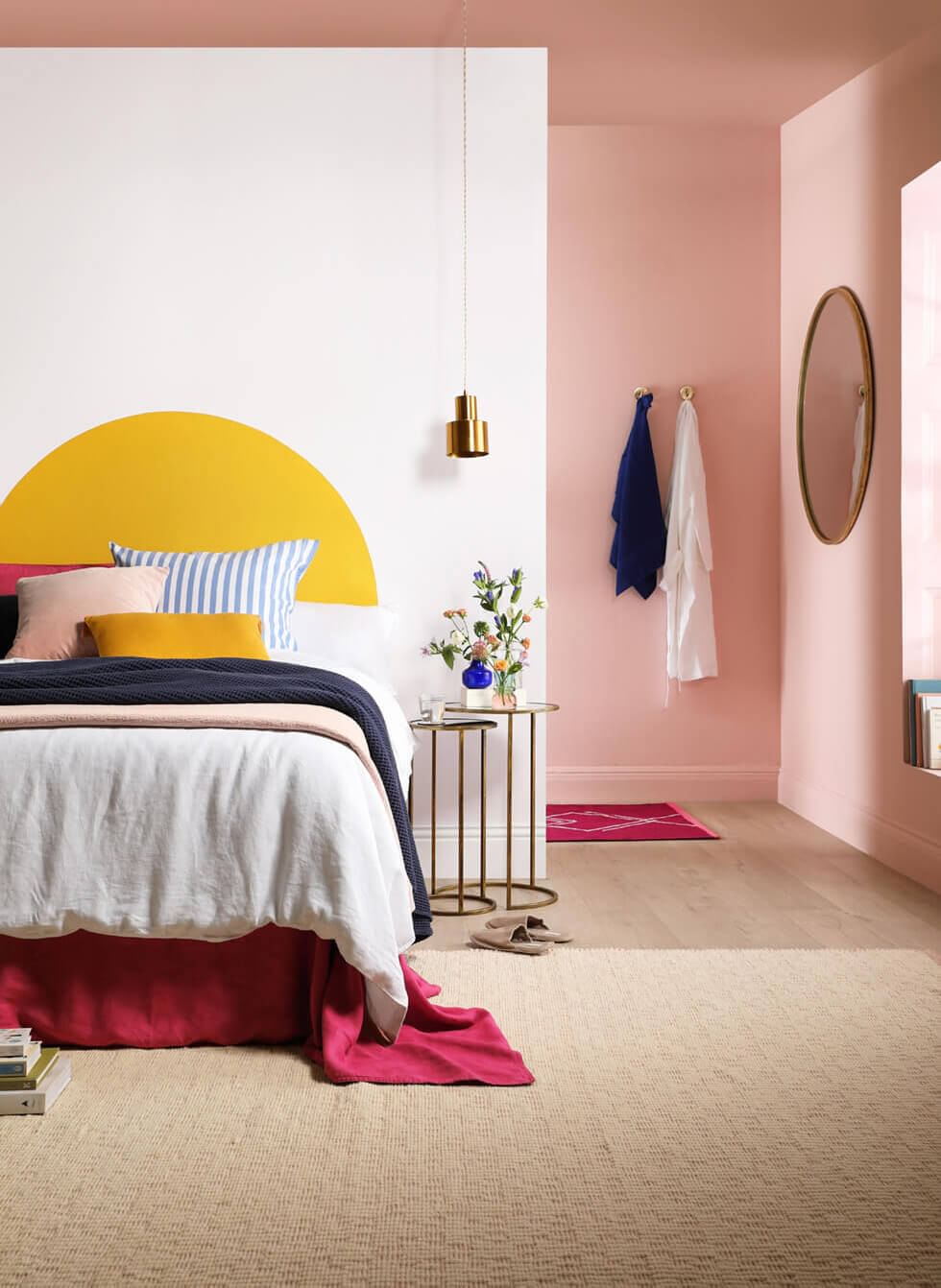 Bedroom with yellow arch and pastel pink walls