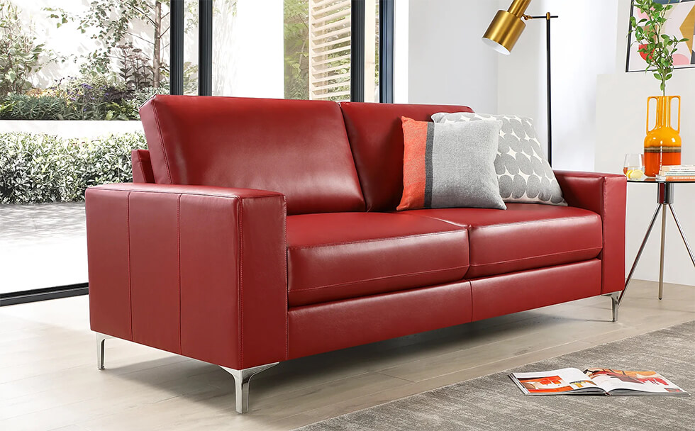 Bold red leather sofa in a modern living room with grey pillows