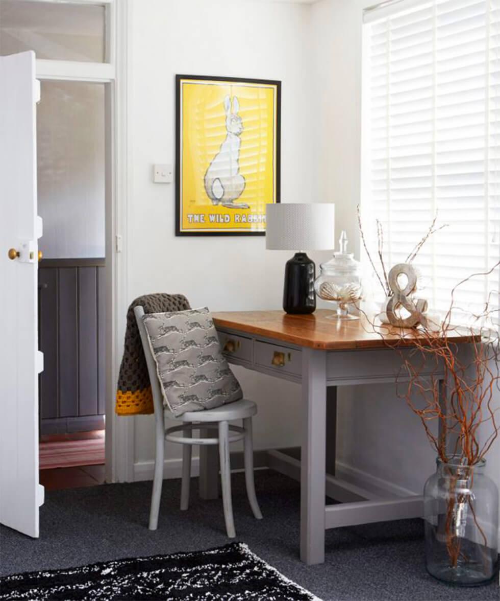  Grey and yellow home office with framed art