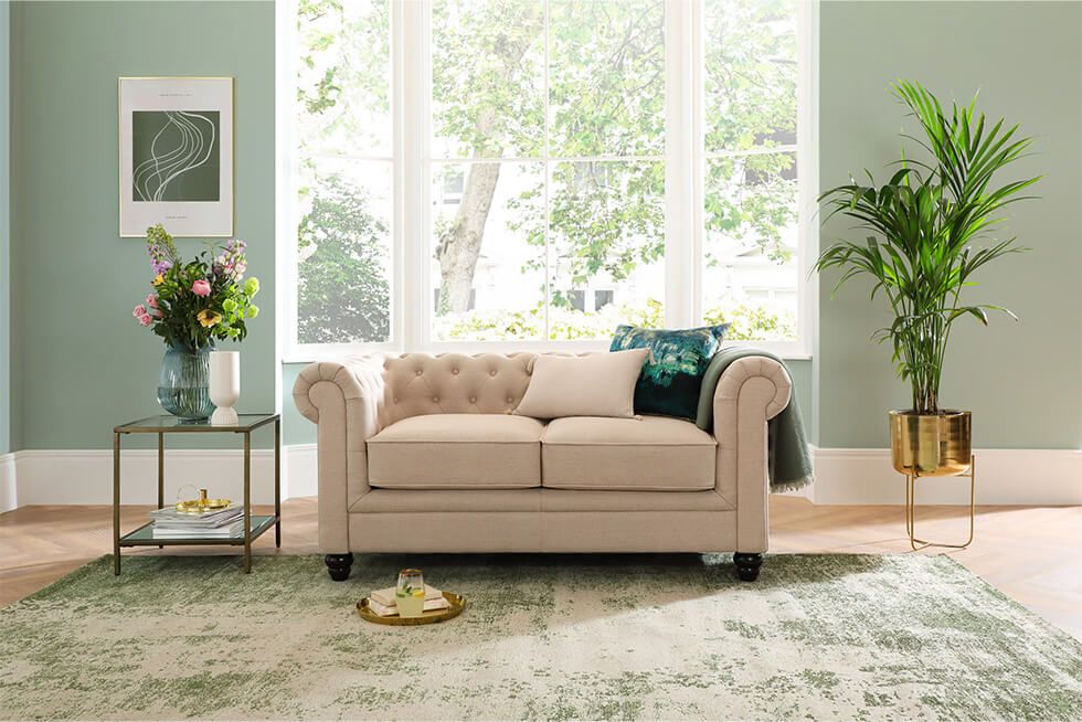 Timeless Chesterfield sofa in oatmeal shade in light breezy living room