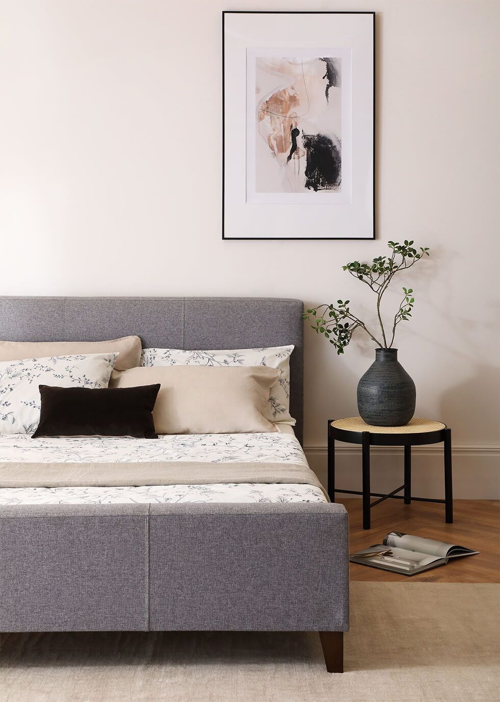 Understated and timeless bedroom with stylish grey fabric bed