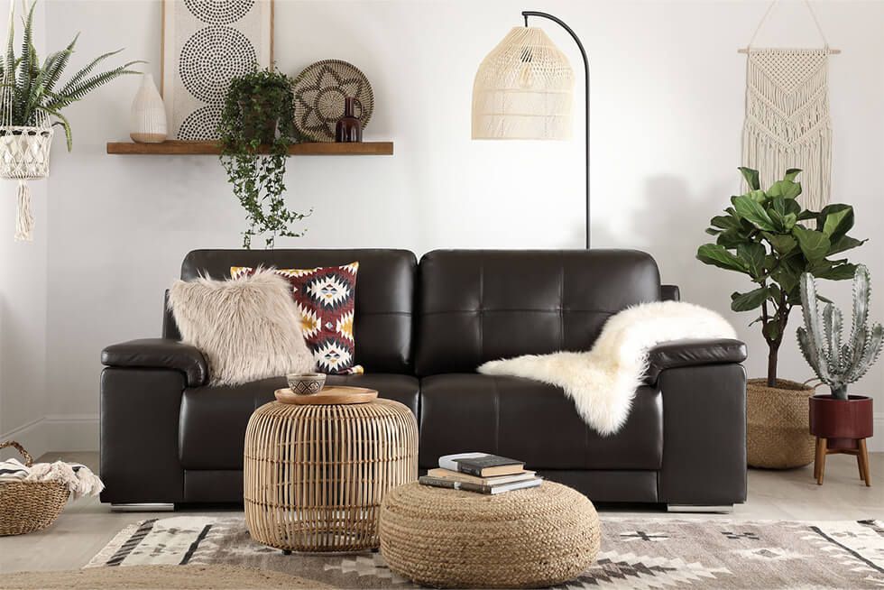 Modern leather sofa with bohemian accessories in a timeless living room