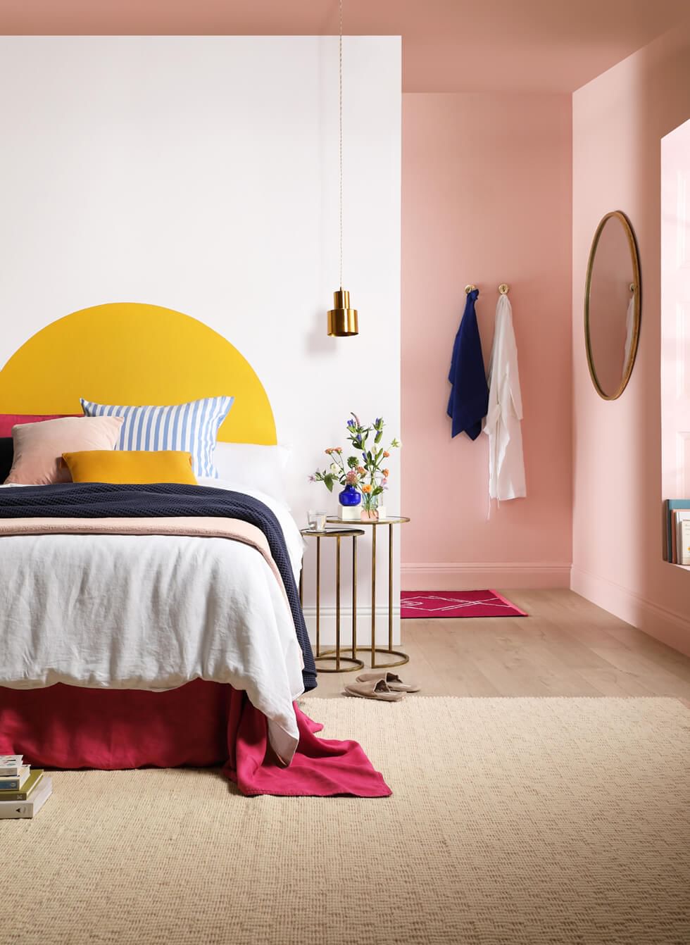 Pink and yellow bedroom with pastel and Viva Magenta accessories