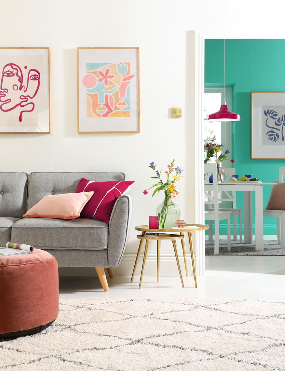 White living room with grey sofa and Viva Magenta accessories