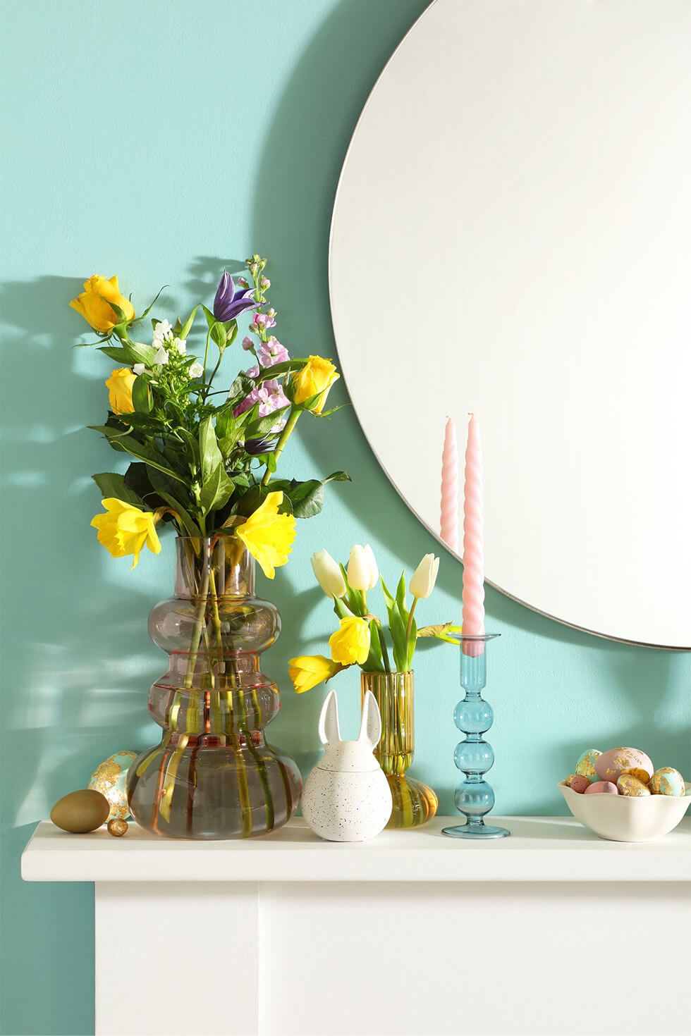 Easter mantelpiece with flowers, eggs and bunny motifs