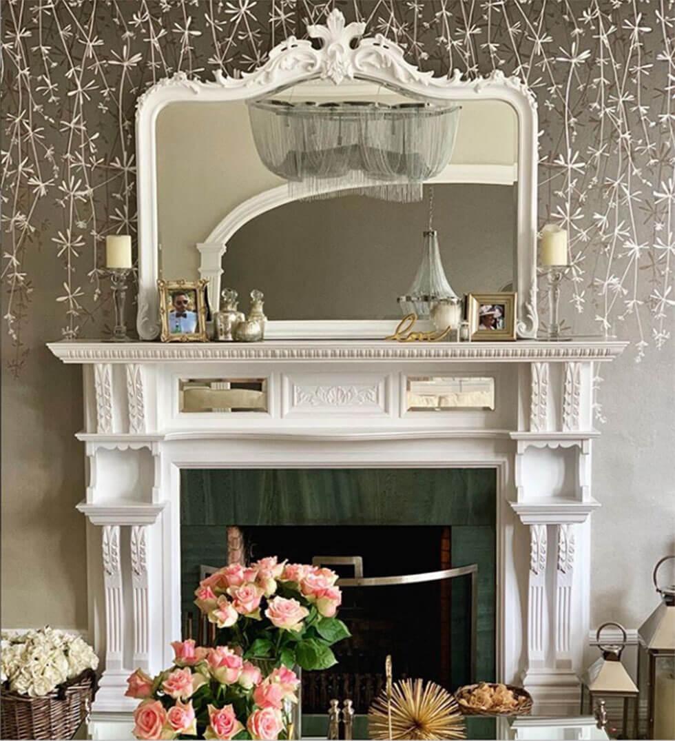 White fireplace with mirror and chic accessories